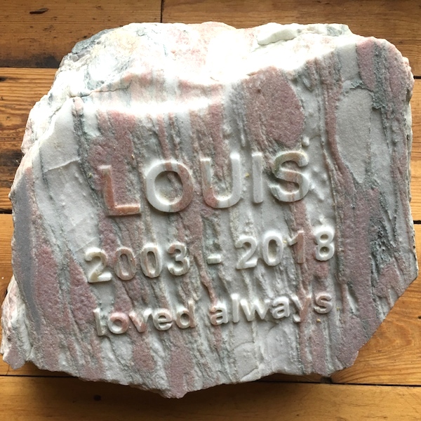 Pet memorials in stone. A rose marble pet memorial for Louis in the garden