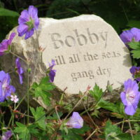 Sandstone Pet Memorial Boulder for Bobby in the Garden amongst the Geraniums