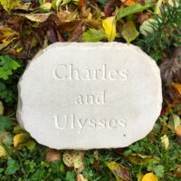 Sandstone Pet Memorial Plaque for Charles & Ulyssess lying Flat in the Garden